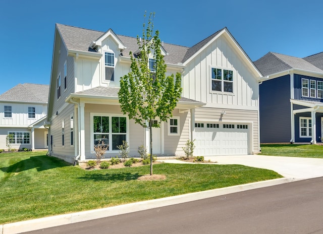 view of front of house featuring a garage and a front lawn