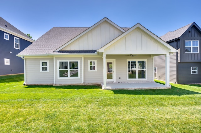 rear view of property with a yard, ceiling fan, and a patio area