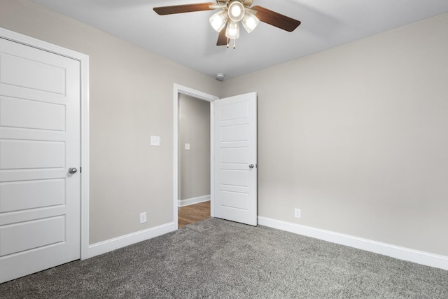 unfurnished bedroom with ceiling fan, a closet, and dark colored carpet