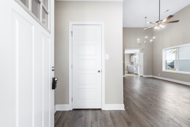 entrance foyer featuring ceiling fan with notable chandelier, high vaulted ceiling, and dark wood-type flooring