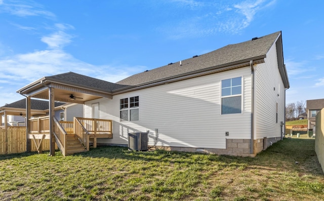 back of property with cooling unit, a yard, ceiling fan, and a wooden deck