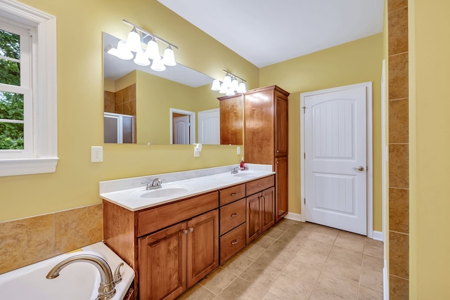 bathroom with tile floors, a bathing tub, and double sink vanity