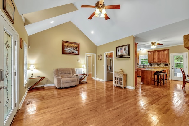 living room featuring ceiling fan and light wood-type flooring