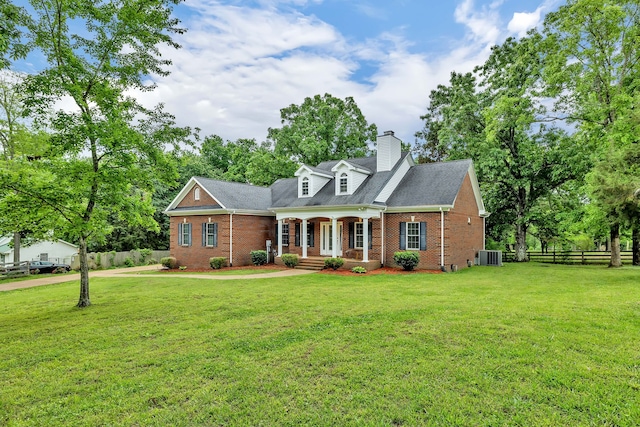 cape cod house with central AC and a front lawn