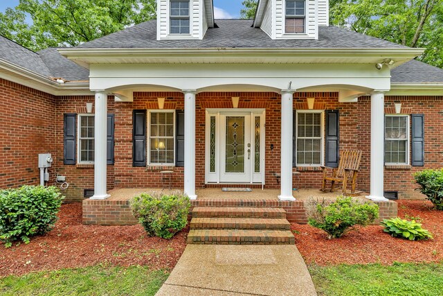 entrance to property featuring covered porch