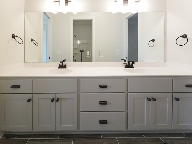 bathroom featuring tile floors and dual bowl vanity