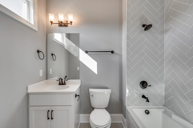 full bathroom with vanity, toilet, and tiled shower / bath