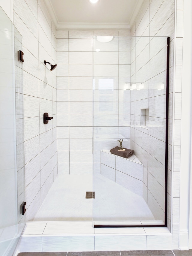 bathroom with crown molding and tiled shower