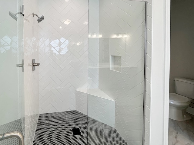 bathroom featuring walk in shower and toilet