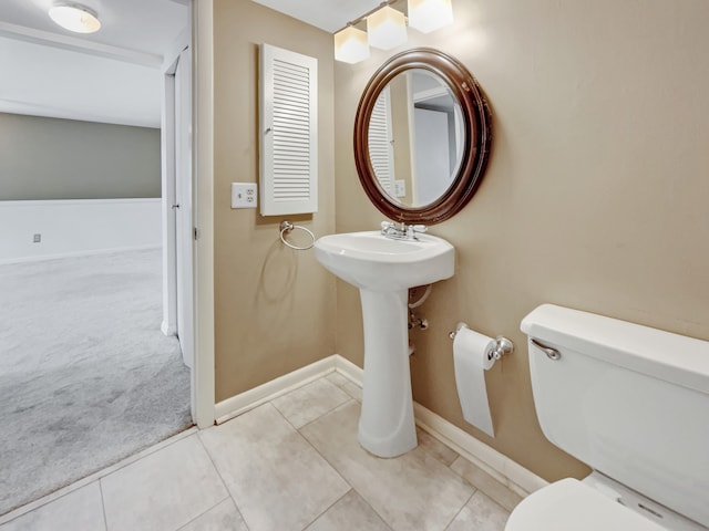 bathroom featuring toilet and tile floors