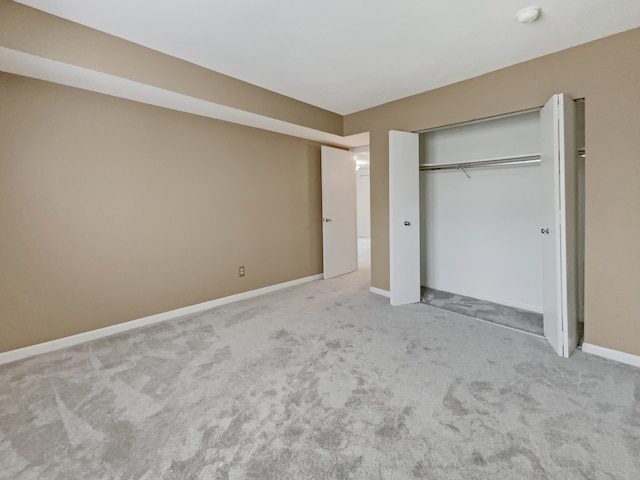 unfurnished bedroom featuring a closet and carpet