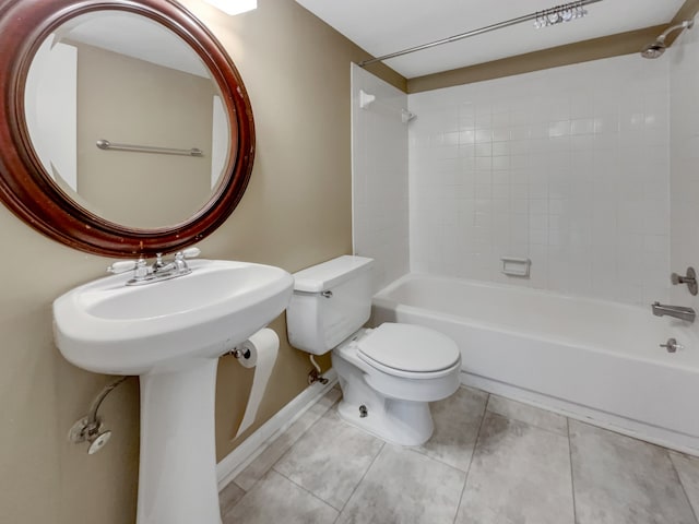 bathroom featuring tiled shower / bath, toilet, and tile floors