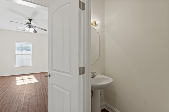 bathroom with hardwood / wood-style flooring and ceiling fan