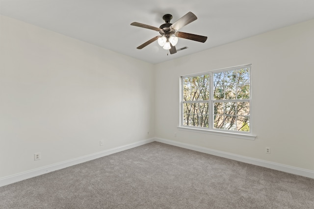 carpeted empty room featuring ceiling fan