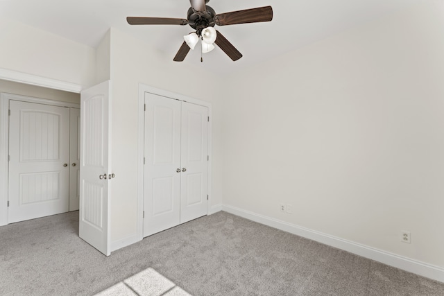 unfurnished bedroom with light carpet, a closet, and ceiling fan