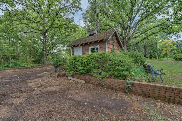 view of property exterior with an outbuilding