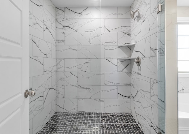 bathroom with tiled shower