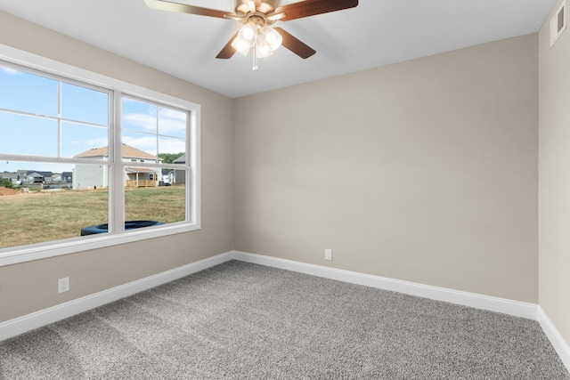 empty room with ceiling fan and carpet floors