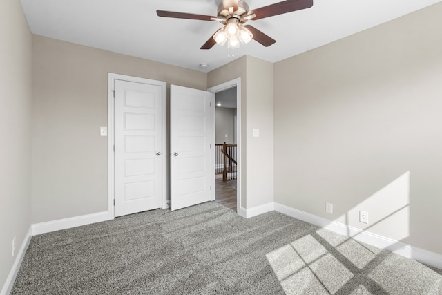 unfurnished bedroom with ceiling fan, a closet, and carpet floors