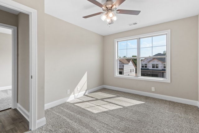 empty room featuring carpet flooring and ceiling fan