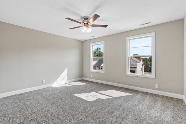 carpeted spare room with ceiling fan