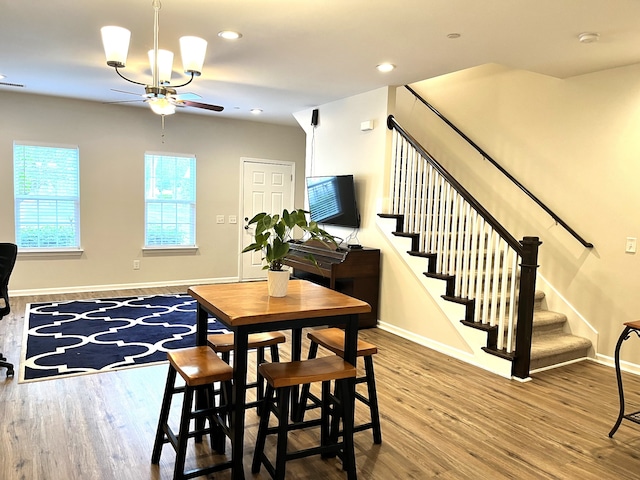 dining area with wood-type flooring and ceiling fan