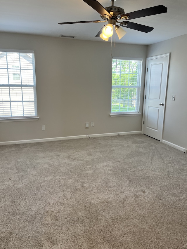 unfurnished room featuring carpet and ceiling fan