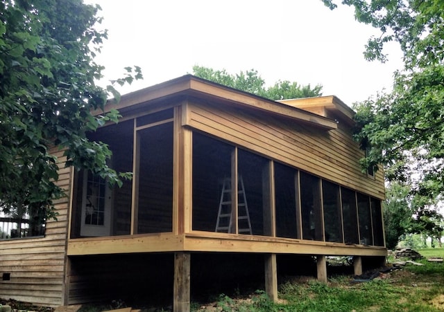 view of side of home with a sunroom