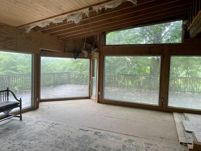 unfurnished sunroom featuring lofted ceiling