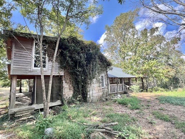 back of house featuring a porch