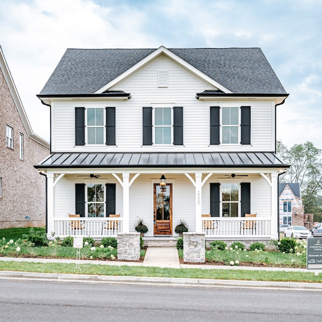 modern farmhouse style home with ceiling fan and covered porch