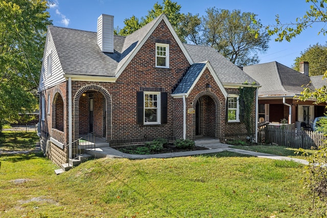 english style home with a front lawn