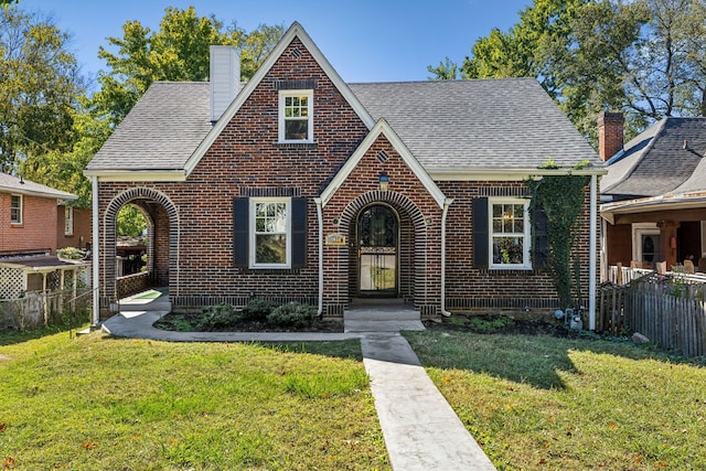 tudor home with a front yard