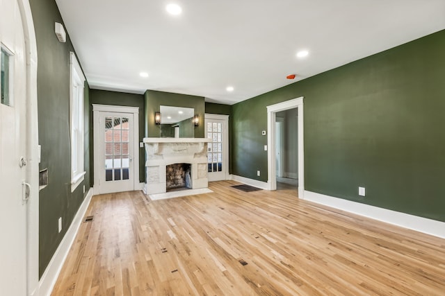 unfurnished living room with light hardwood / wood-style flooring