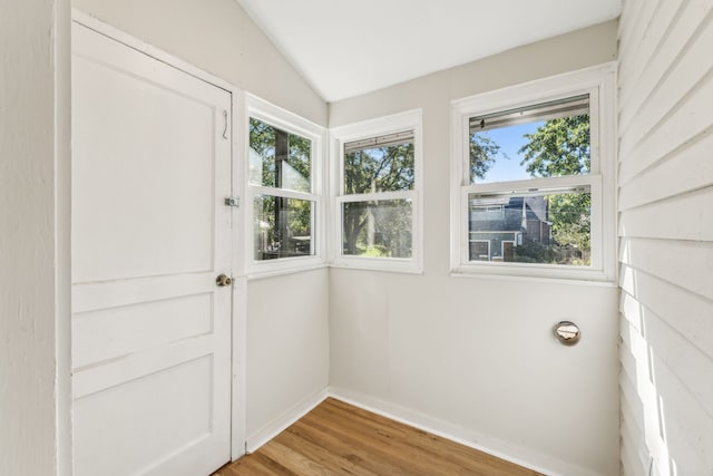 unfurnished sunroom with lofted ceiling and a healthy amount of sunlight