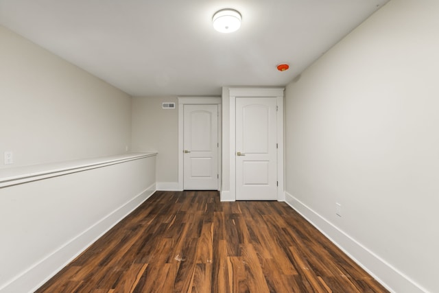 unfurnished bedroom with dark wood-type flooring