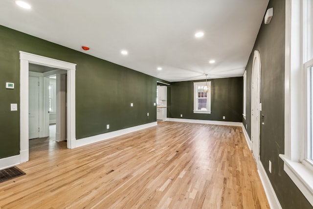 spare room with light hardwood / wood-style flooring