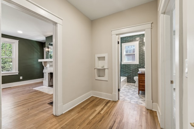 hall with light hardwood / wood-style floors