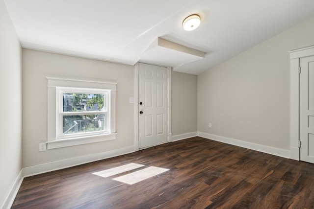 entryway with lofted ceiling and dark hardwood / wood-style flooring