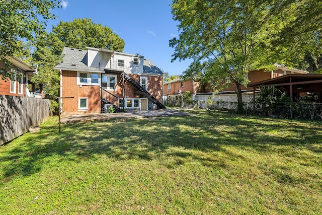 rear view of house with a yard