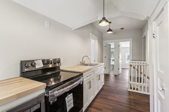 kitchen featuring sink, dark hardwood / wood-style flooring, hanging light fixtures, white cabinets, and stainless steel electric range oven