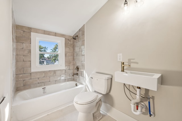 full bathroom with tiled shower / bath, vaulted ceiling, toilet, sink, and tile patterned floors