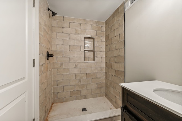 bathroom featuring vanity and a tile shower