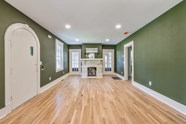 unfurnished living room with light wood-type flooring