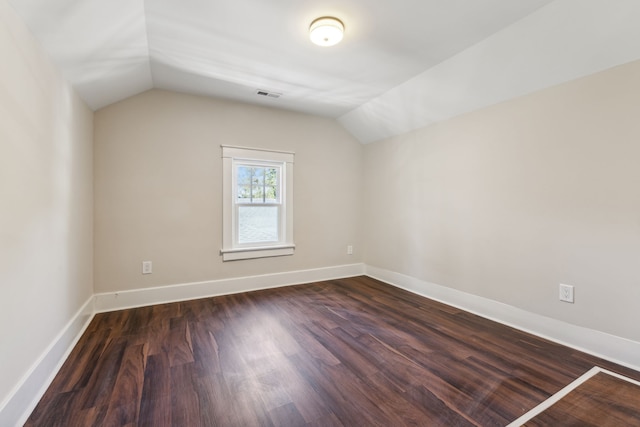 bonus room featuring lofted ceiling and dark hardwood / wood-style flooring