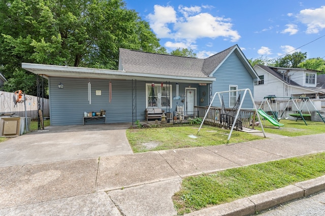 view of front facade with a playground, a front yard, and a porch