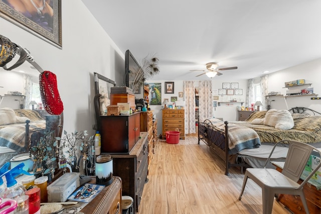 bedroom with light wood-type flooring and ceiling fan