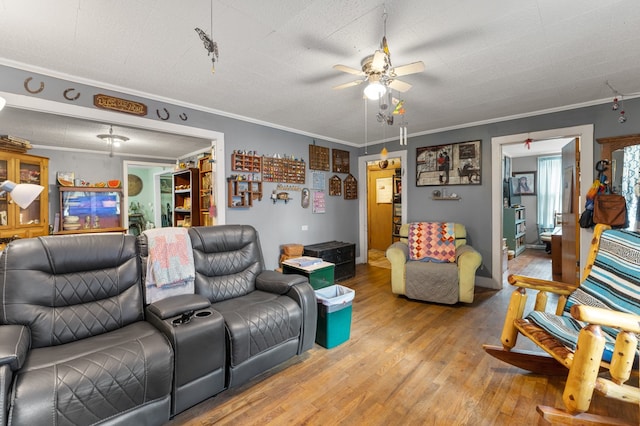 living room with a textured ceiling, ornamental molding, and hardwood / wood-style floors