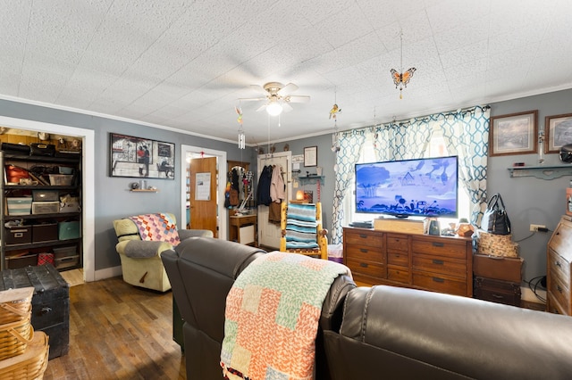 living room featuring ornamental molding, ceiling fan, and dark hardwood / wood-style flooring