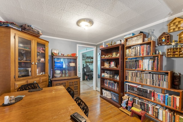 office space with ornamental molding and light wood-type flooring